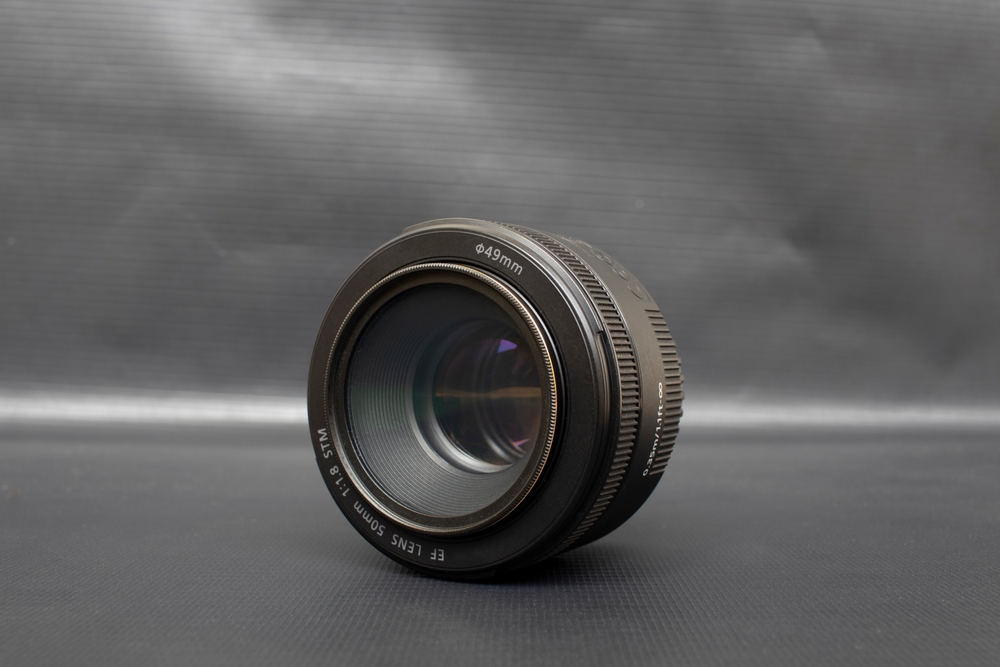 50 mm prime lens on a gray background