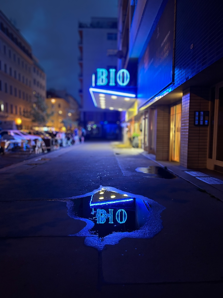 Nighttime scene with a glowing neon sign