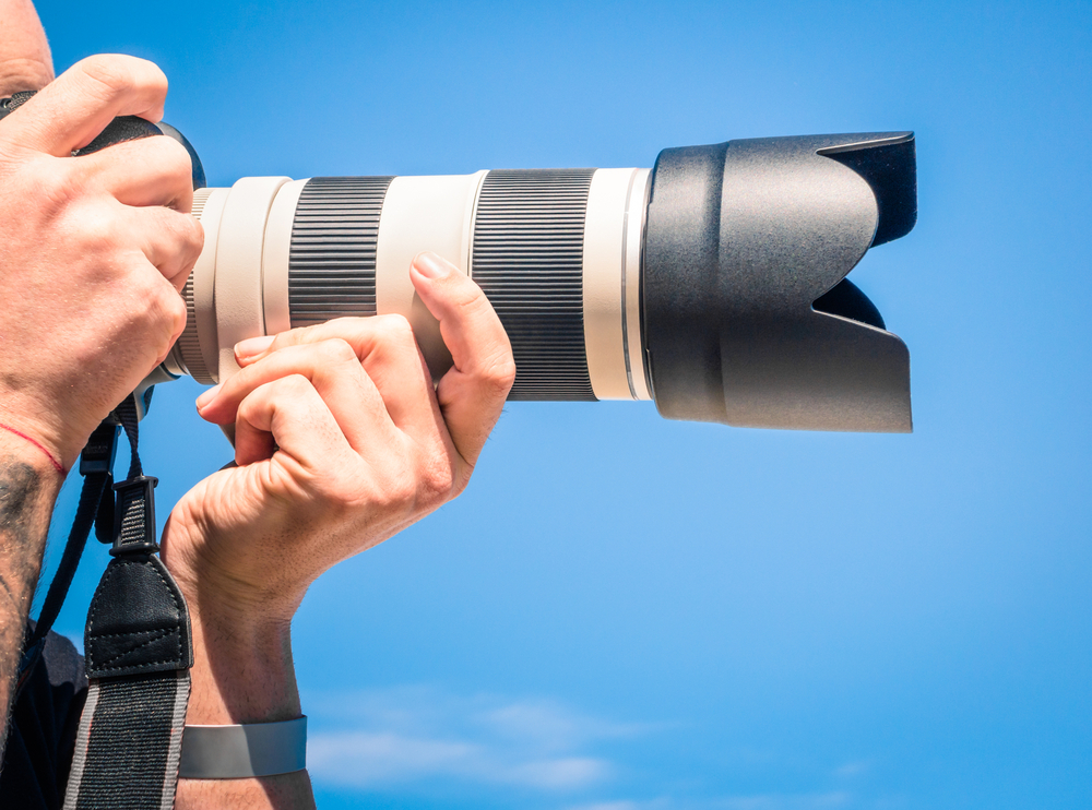 person take a photo with a Large zoom lens
