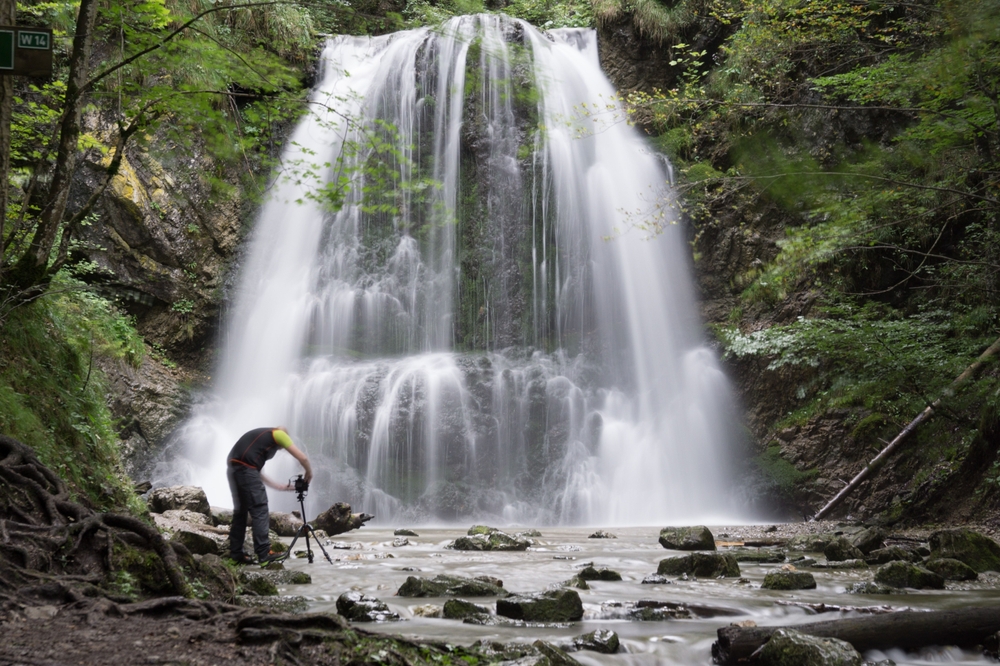 Photographer capturing a waterfall