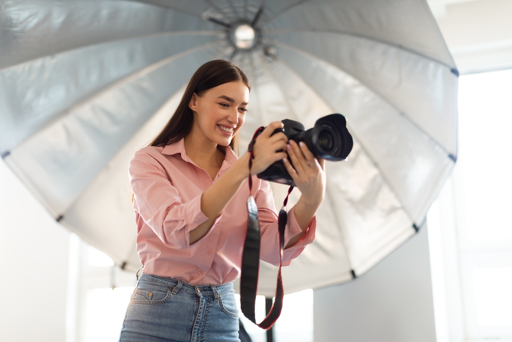  photographer standing in front of reflective umbrella