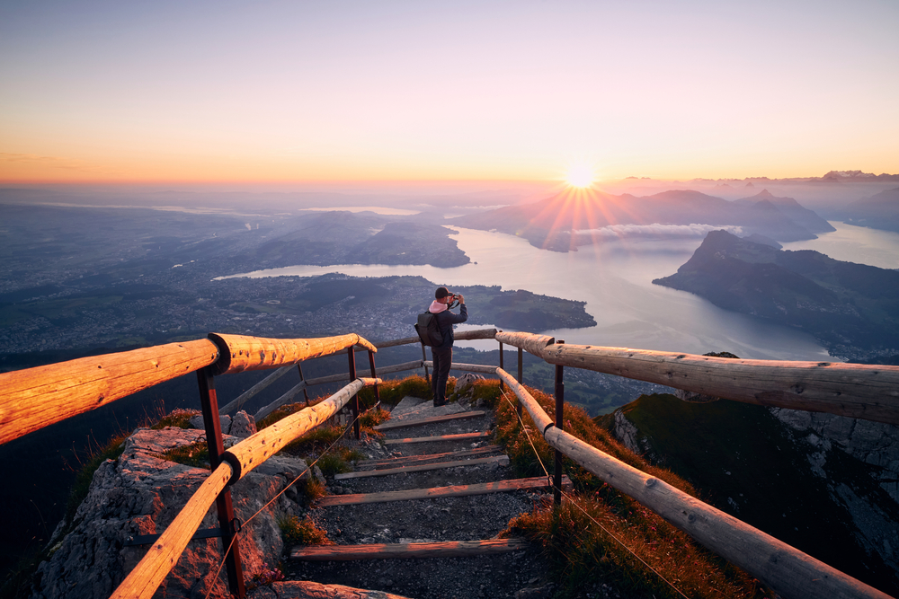 photographer taking a picture of a valley