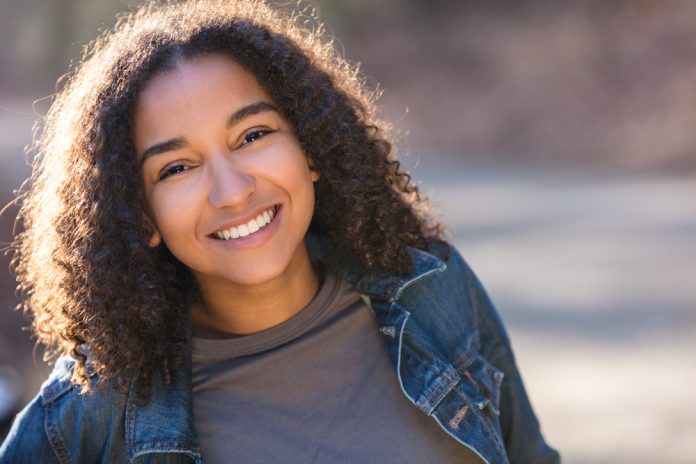 young woman smiling laughing with perfect teeth